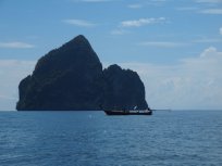 Longboat and island enroute to snorkelling sites