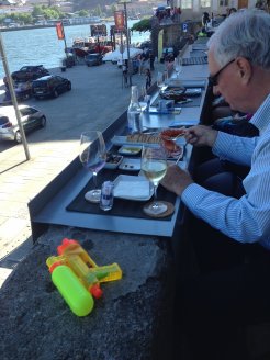 Visitors eating Tapas on the deck next to our apartment--can you guess what the water gun is for?