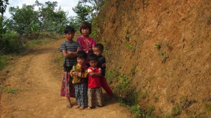 Village children wait for us to pass -- they look a little hostile